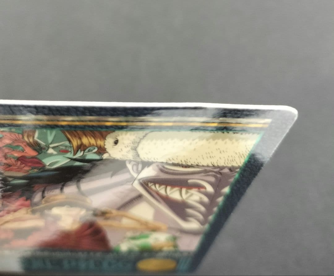 One Piece Carddass Visual Adventure 61 trading card showing Arlong Park with slight edge wear and sun fading on the back