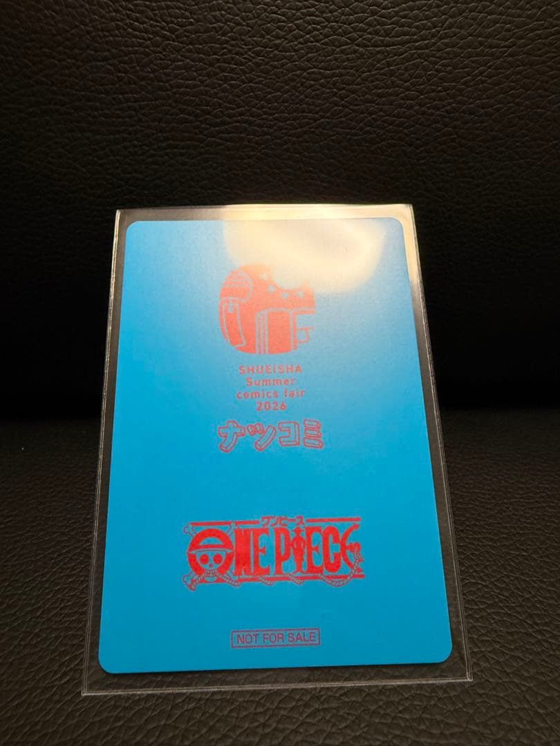 One Piece Natsucomi 2026 Metakira card featuring Monkey D. Luffy signed by Eiichiro Oda in protective sleeve
