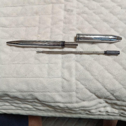 Cross metal ballpoint pen in silver with twist design shown on white background