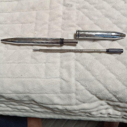 Cross metal ballpoint pen in silver with twist design shown on white background