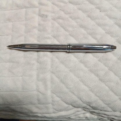 Cross metal ballpoint pen in silver with twist design shown on white background