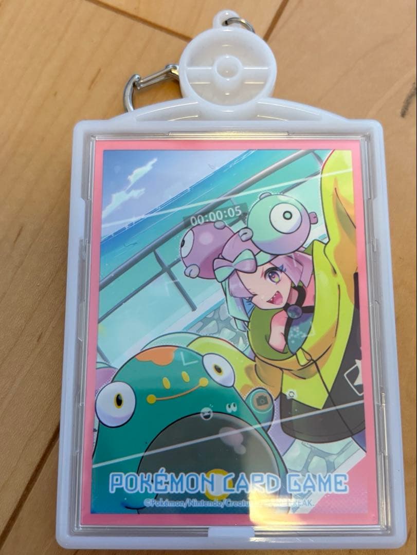 Niufia GX SSR Pokemon card in official sleeve with keychain holder, showing some scratches and folded packaging