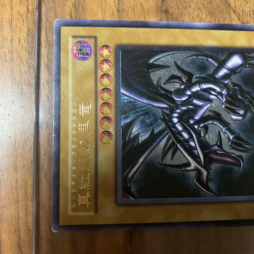 Yu-Gi-Oh Red-Eyes Black Dragon Ultimate Rare Relief Card 301-056 showing front sleeve with light reflection