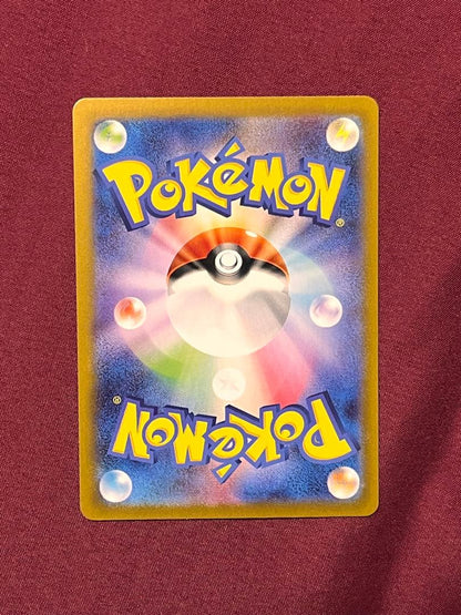 Close-up of Pokemon Charizard EX SV2A SR 185/165 trading card in protective sleeve and rigid loader