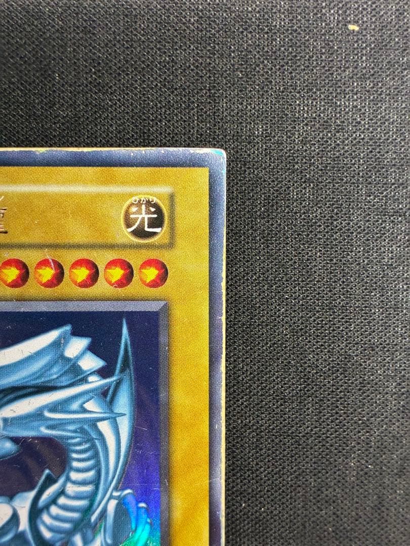 Blue-Eyes White Dragon Yu-Gi-Oh! trading card in early condition with visible signs of use