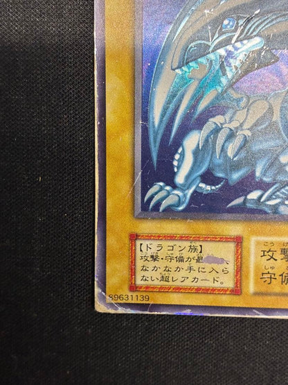Blue-Eyes White Dragon Yu-Gi-Oh! trading card in early condition with visible signs of use