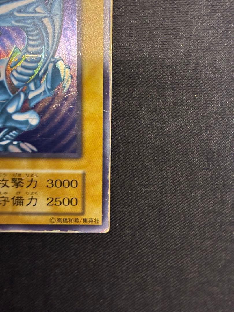 Blue-Eyes White Dragon Yu-Gi-Oh! trading card in early condition with visible signs of use