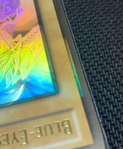 Blue Eyes White Dragon Ghost Rare hologram error Yu-Gi-Oh card with edge-overlapping hologram in protective sleeve