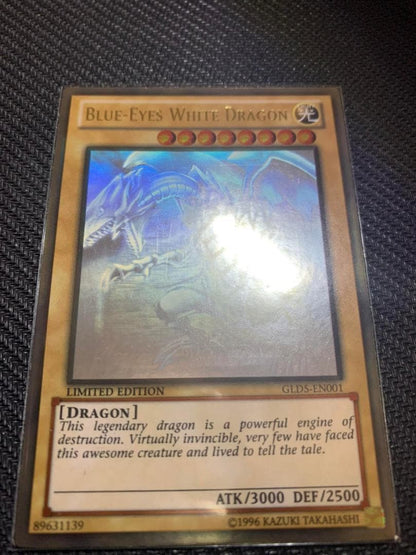 Blue Eyes White Dragon Ghost Rare hologram error Yu-Gi-Oh card with edge-overlapping hologram in protective sleeve