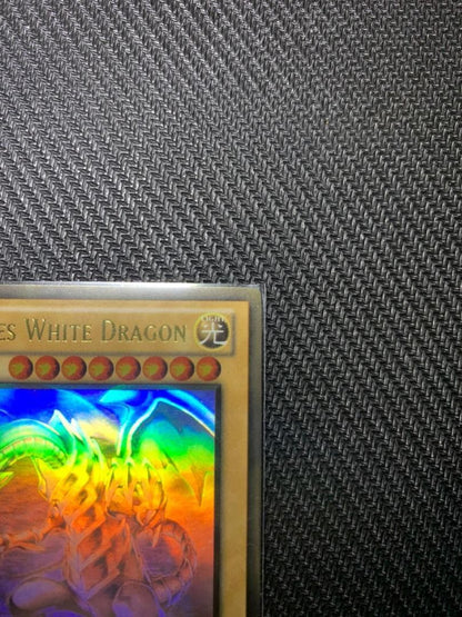 Blue Eyes White Dragon Ghost Rare hologram error Yu-Gi-Oh card with edge-overlapping hologram in protective sleeve