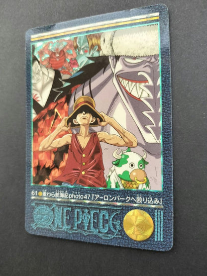 One Piece Carddass Visual Adventure 61 trading card showing Arlong Park with slight edge wear and sun fading on the back