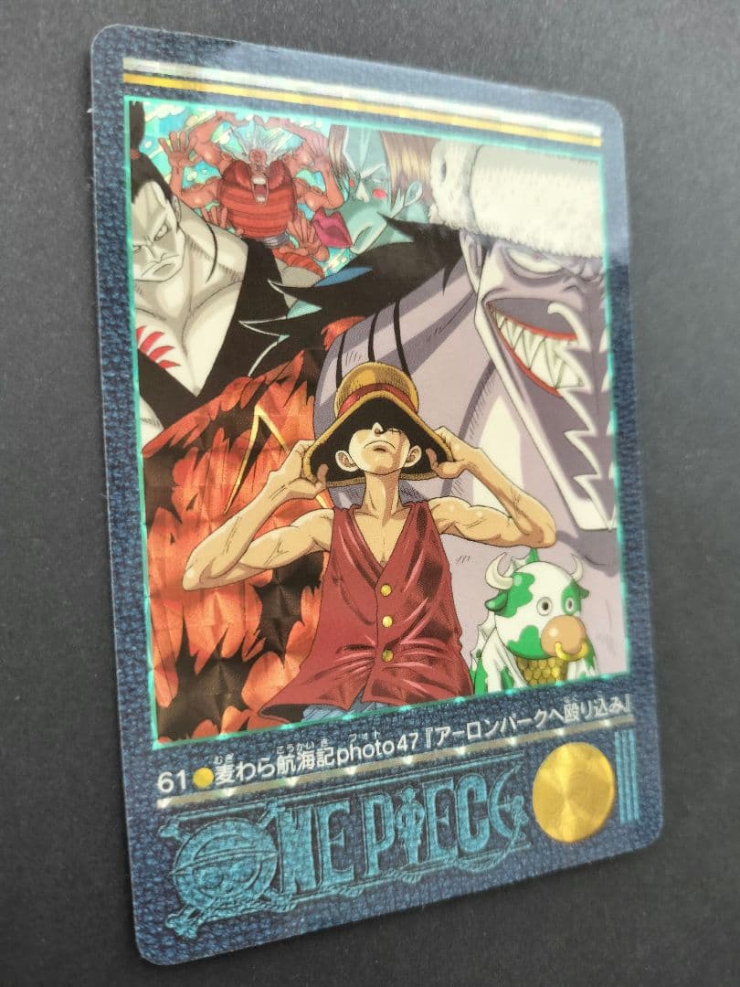 One Piece Carddass Visual Adventure 61 trading card showing Arlong Park with slight edge wear and sun fading on the back