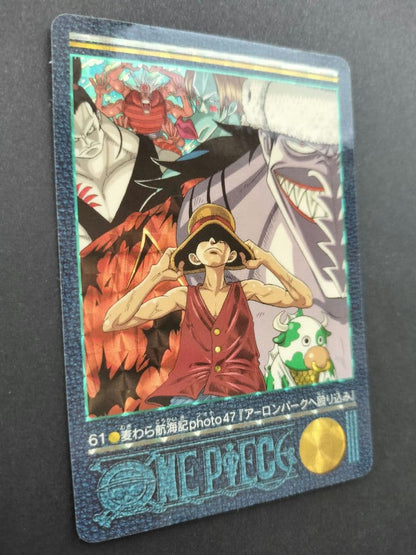 One Piece Carddass Visual Adventure 61 trading card showing Arlong Park with slight edge wear and sun fading on the back
