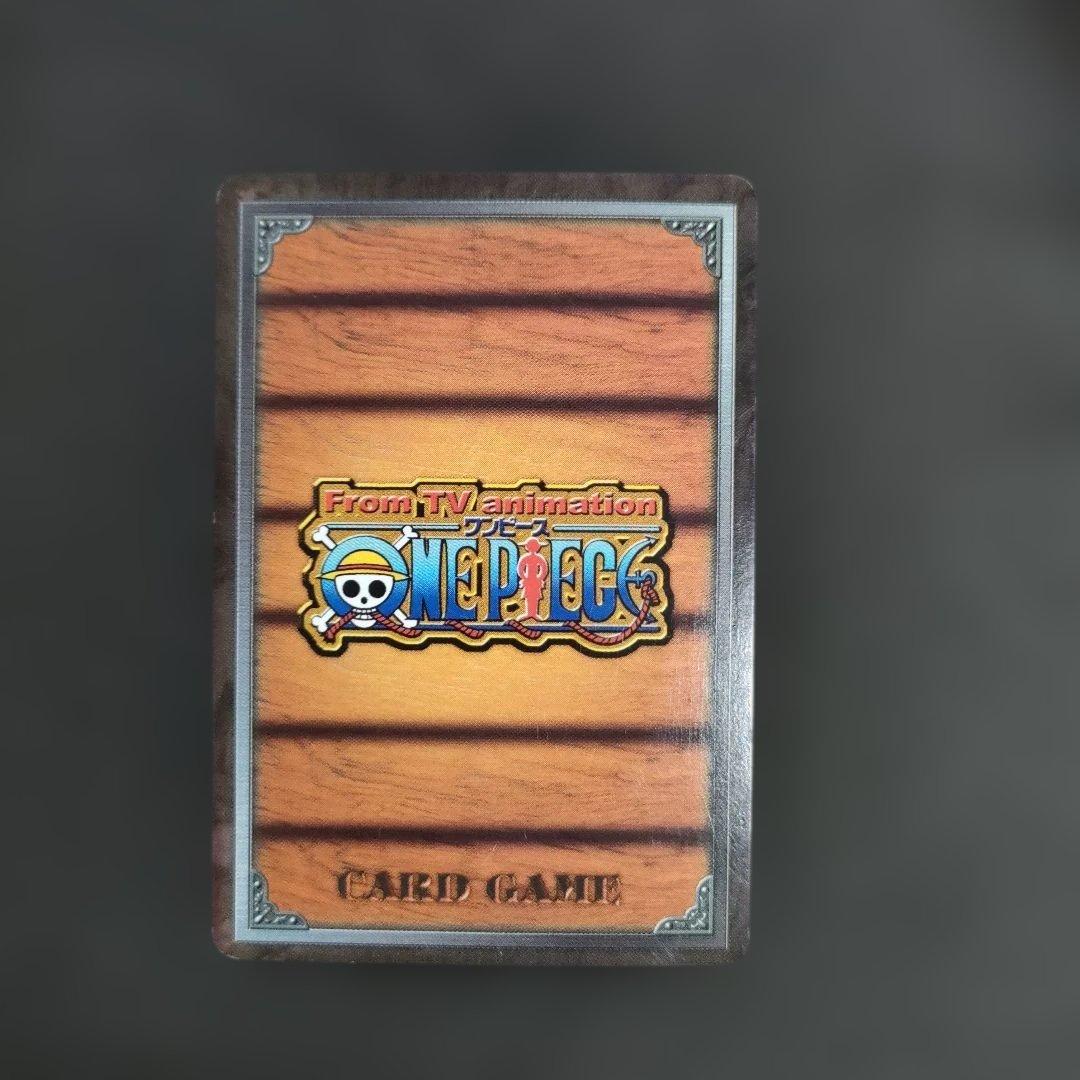 Old One Piece Monkey D. Luffy MS-C10 Pirate's Beacon trading card with signs of aging and damage