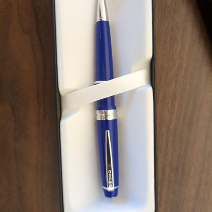 Cross ballpoint pen with vibrant blue body and silver clip featuring a simple, sophisticated design