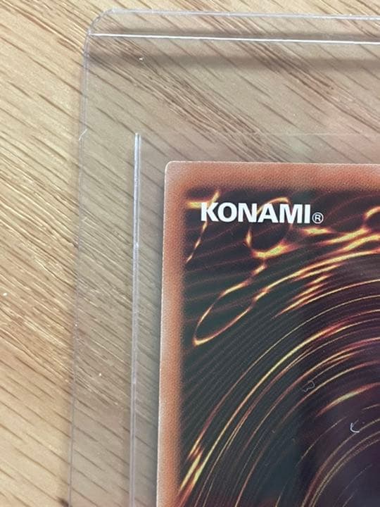 Yu-Gi-Oh Galaxy Eyes Afterglow Dragon 20th trading card with visible scratches and wear in protective loader