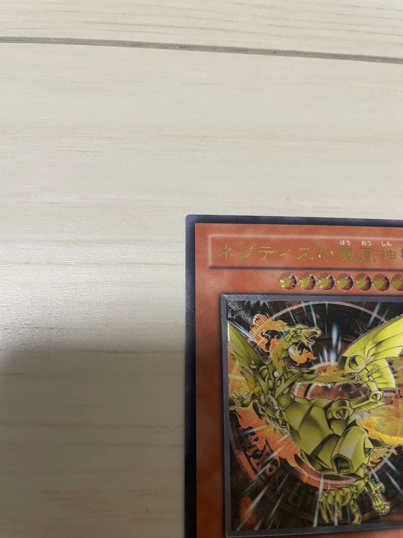 Used Yu-Gi-Oh Nephthys the Phoenix God Ultimate Rare Pleafer Card in screw-down holder with visible scratches and dirt
