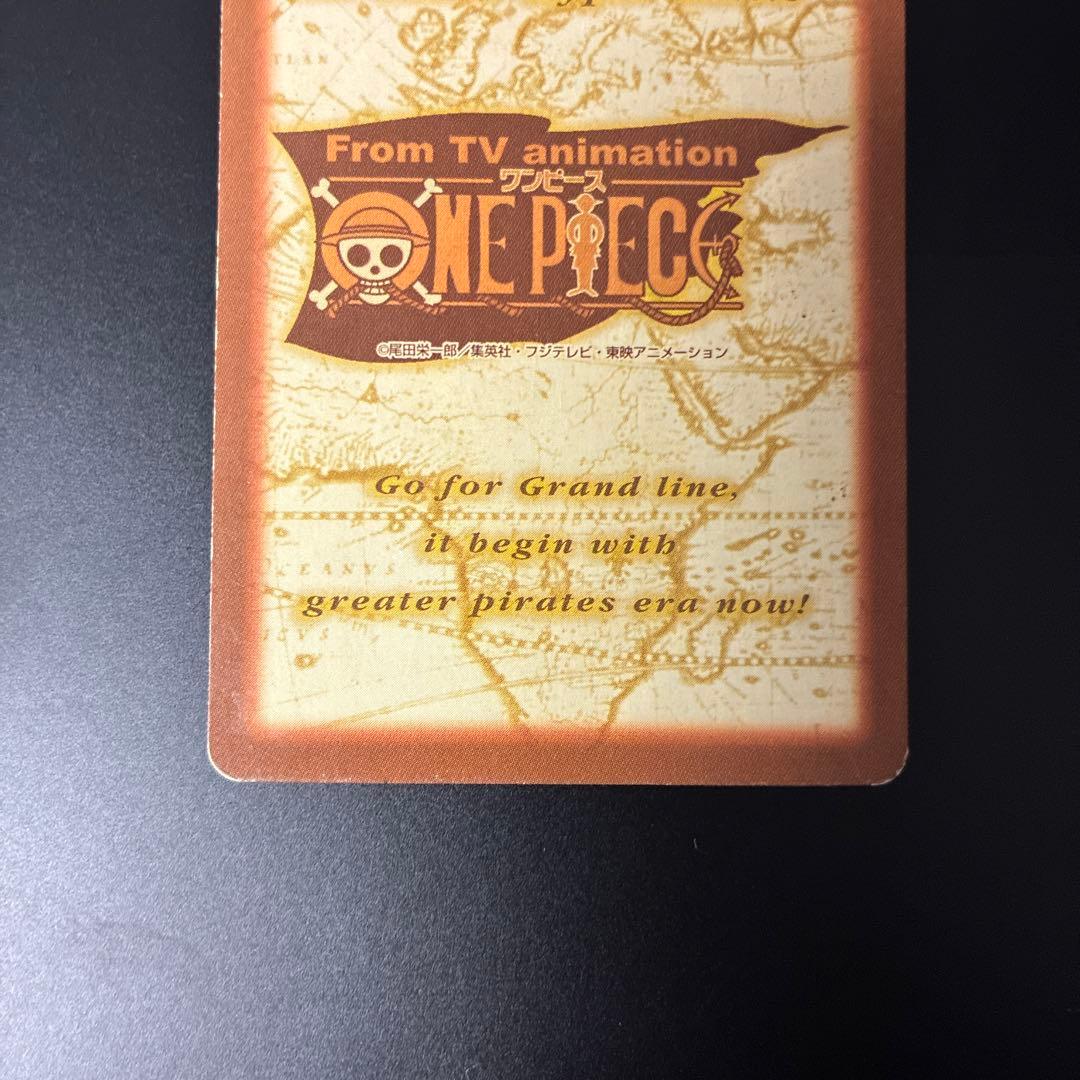 Bandai One Piece Buggy C24 Treasure Hyper Battle Japanese card with signs of aging in a rigid waterproof case