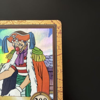 Bandai One Piece Buggy C24 Treasure Hyper Battle Japanese card with signs of aging in a rigid waterproof case