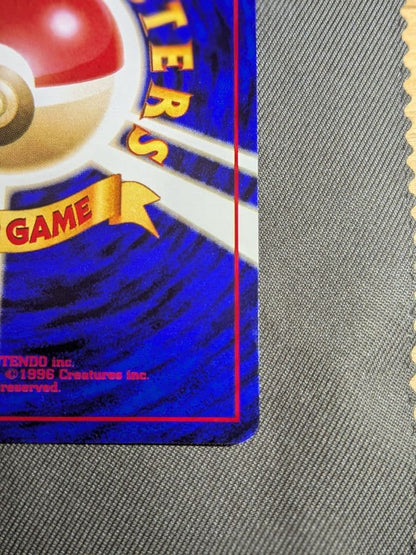 Bandai Pokemon Charizard old collectible card from the Katsura series with visible scratches and signs of storage