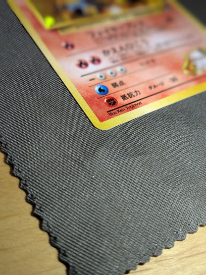 Bandai Pokemon Charizard old collectible card from the Katsura series with visible scratches and signs of storage