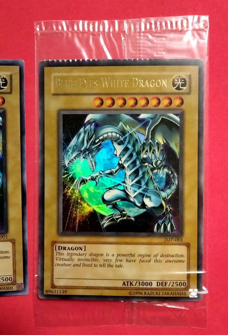 Blue-Eyes White Dragon Ultra Rare 2-card set with top-left crack error in sealed original packaging