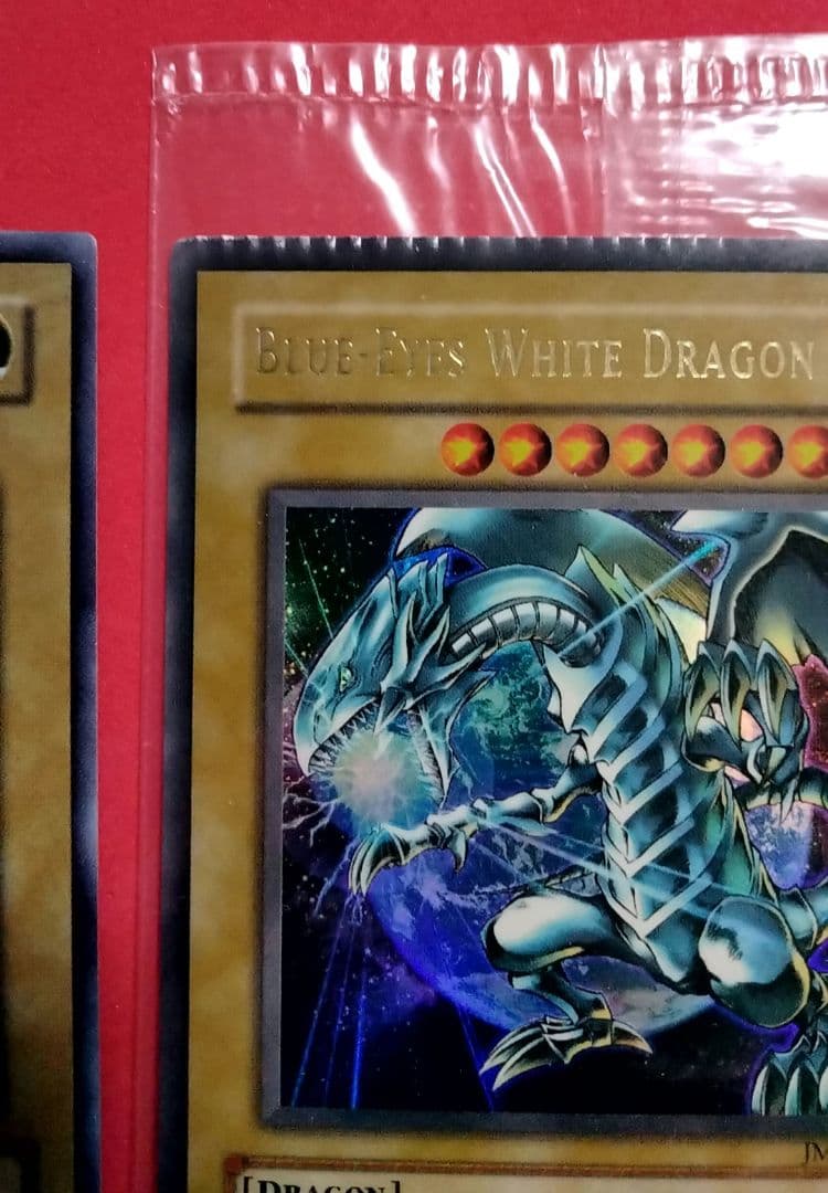Blue-Eyes White Dragon Ultra Rare 2-card set with top-left crack error in sealed original packaging