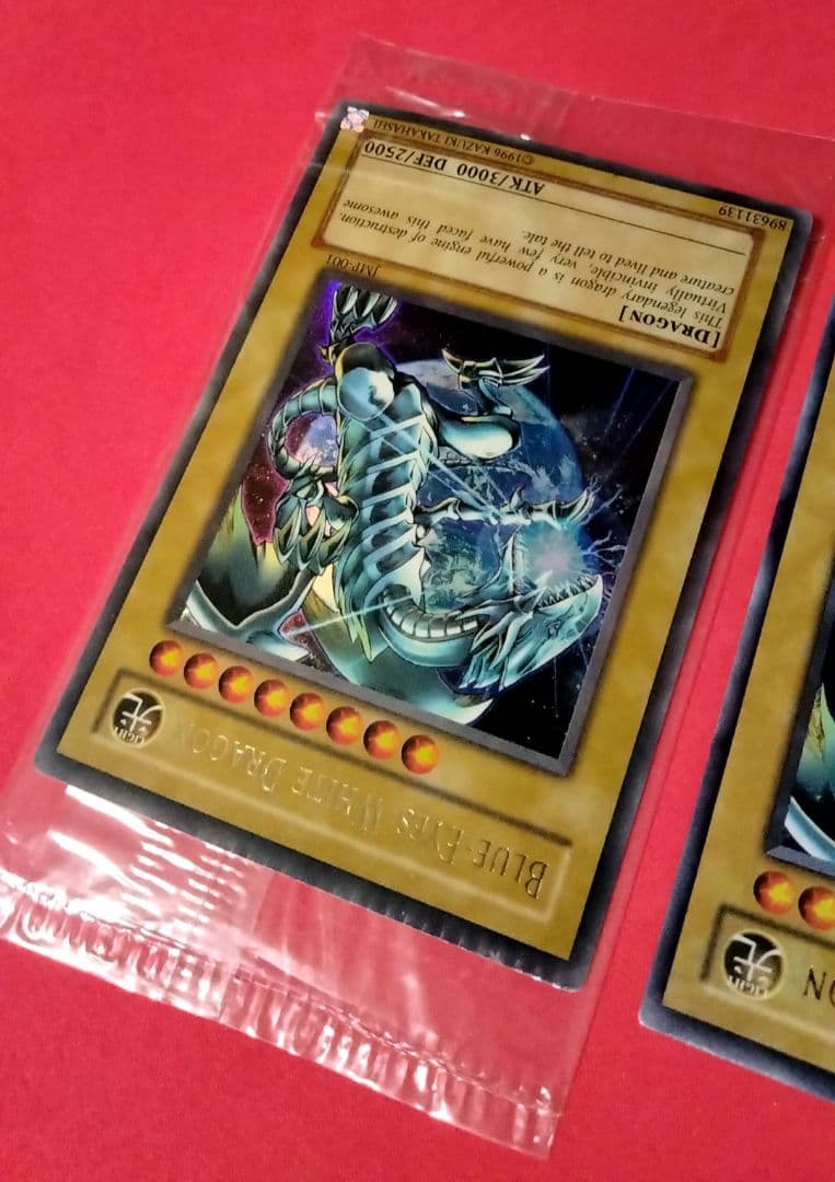 Blue-Eyes White Dragon Ultra Rare 2-card set with top-left crack error in sealed original packaging