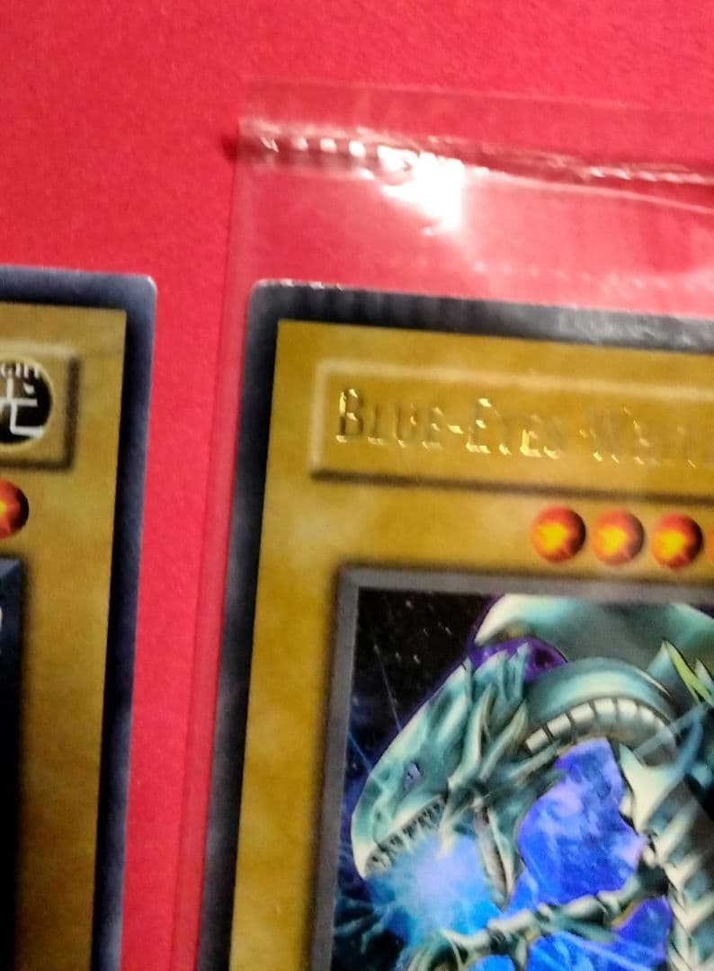 Blue-Eyes White Dragon Ultra Rare 2-card set with top-left crack error in sealed original packaging