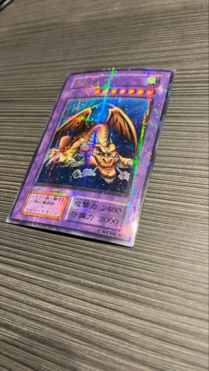 Initial edition Yugioh Millennium Dragon card from Japan with surface scratches and slight corner bend in used condition