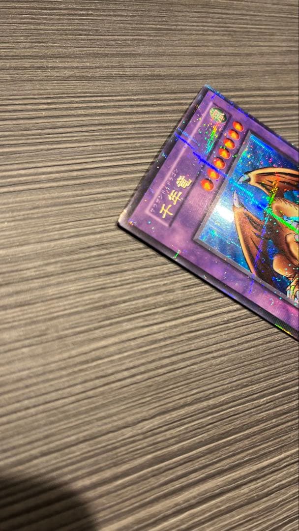 Initial edition Yugioh Millennium Dragon card from Japan with surface scratches and slight corner bend in used condition