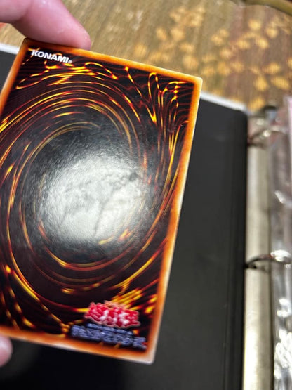 Blue-Eyes White Dragon Ultra Rare Yu-Gi-Oh! OCG card from starter box with visible wear