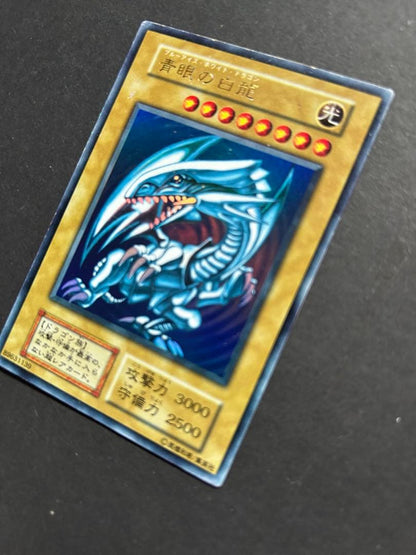 Blue-Eyes White Dragon Ultra Rare Yu-Gi-Oh! OCG card from starter box with visible wear