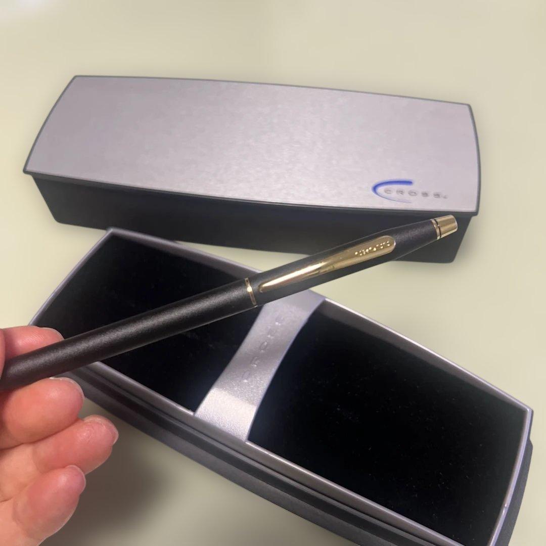 Cross ballpoint pen with matte black body and gold clip displayed with dedicated case