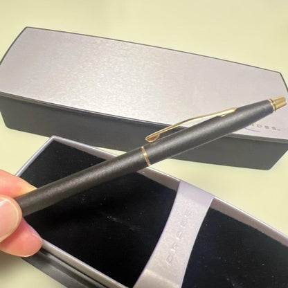 Cross ballpoint pen with matte black body and gold clip displayed with dedicated case