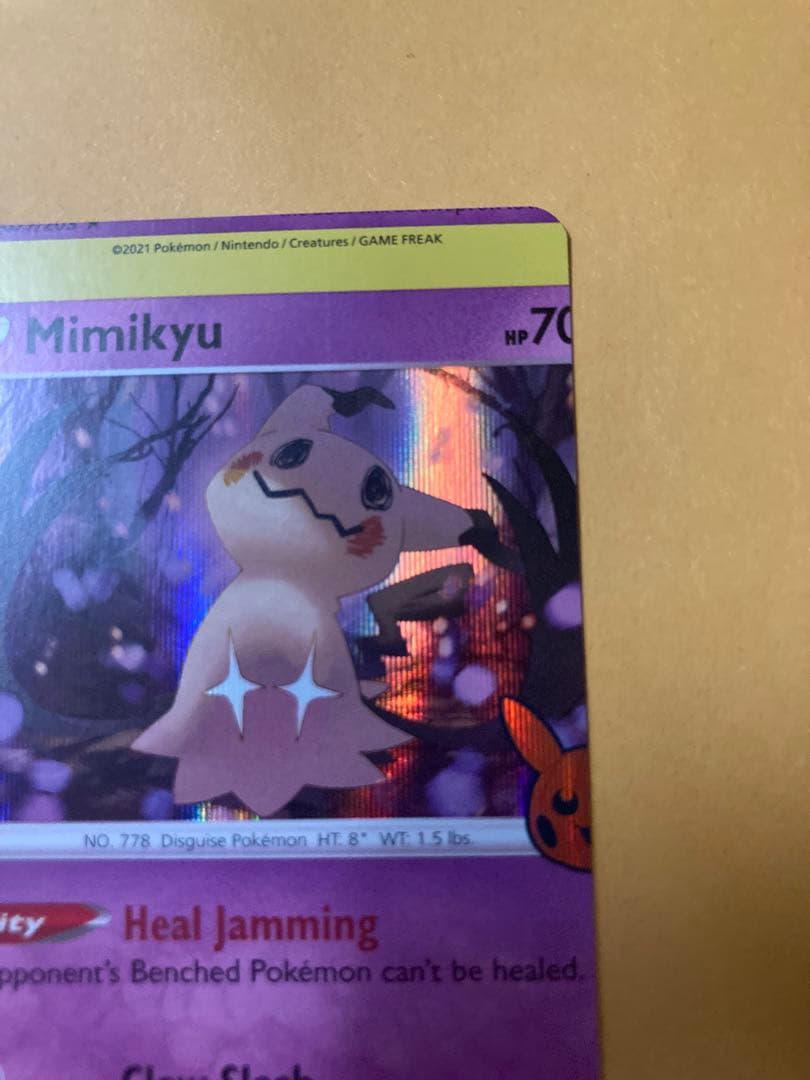Mimikyu Japanese trading card with large vertical and horizontal cutting error from overseas edition