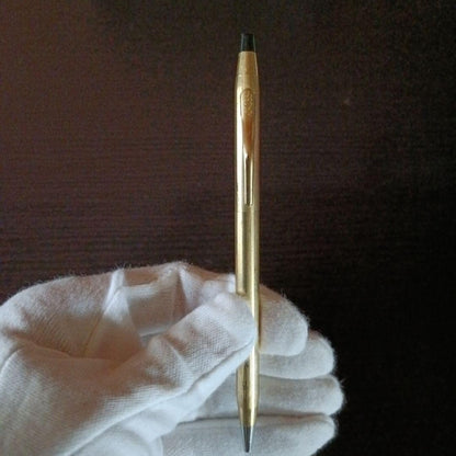 Cross brand gold color twist-operated ballpoint pen with slim sleek design