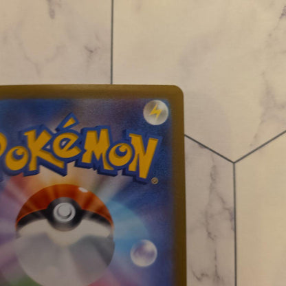 Yu Nagaba Nymphia Pokémon promotional card with minor scratches and protective sleeve