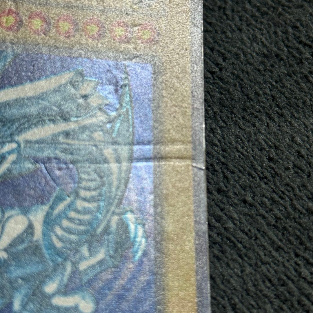 Blue-Eyes White Dragon Ultra Rare Yu-Gi-Oh card early version with scratches and shiny surface from Japan