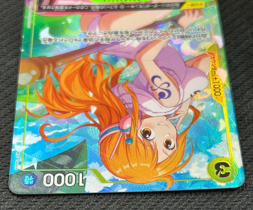 One Piece Nami parallel trading card ST29-008 with a small white blemish at the bottom, Japanese edition