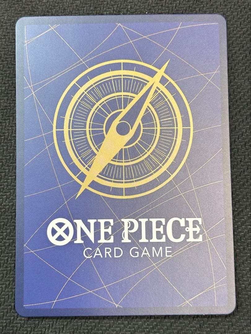 One Piece Nami parallel trading card ST29-008 with a small white blemish at the bottom, Japanese edition