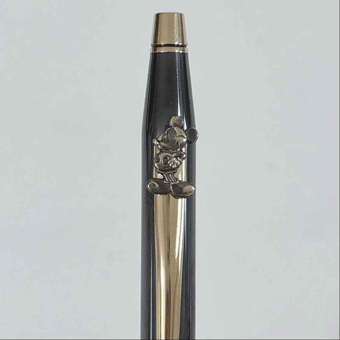 Cross Mickey ballpoint pen with black and gold design featuring Mickey Mouse figure, slight tarnish visible