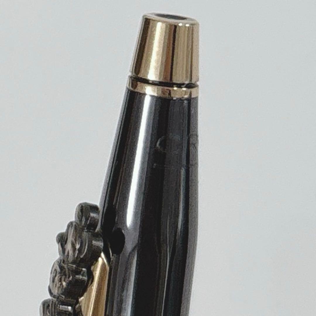 Cross Mickey ballpoint pen with black and gold design featuring Mickey Mouse figure, slight tarnish visible