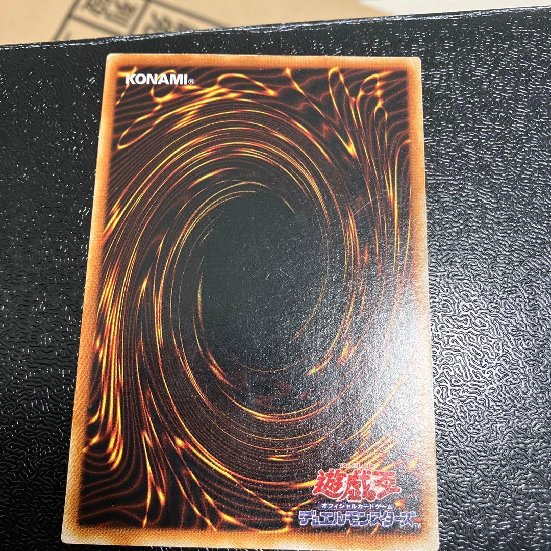 Bandai Toon Black Magician Girl Ultra Rare trading card showing visible wear, dents, creases, and chips