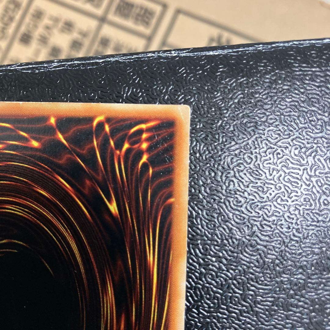 Bandai Toon Black Magician Girl Ultra Rare trading card showing visible wear, dents, creases, and chips