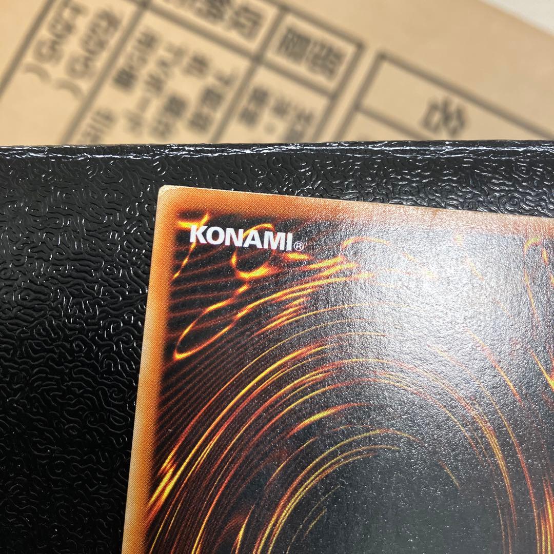 Bandai Toon Black Magician Girl Ultra Rare trading card showing visible wear, dents, creases, and chips