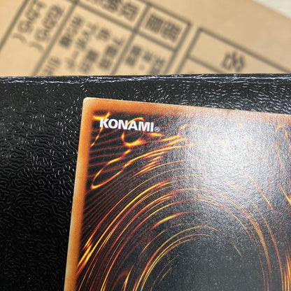 Bandai Toon Black Magician Girl Ultra Rare trading card showing visible wear, dents, creases, and chips