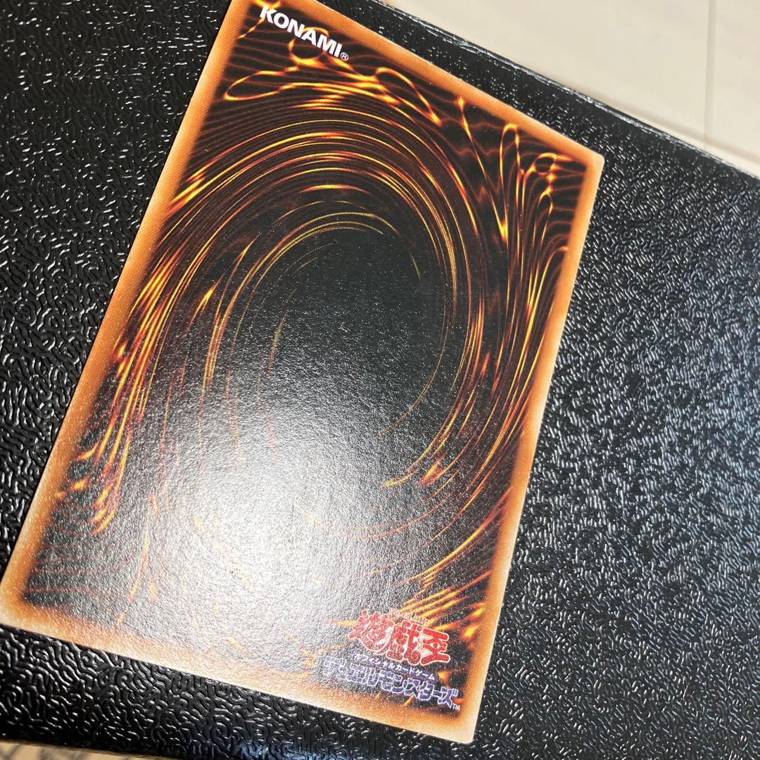 Bandai Toon Black Magician Girl Ultra Rare trading card showing visible wear, dents, creases, and chips