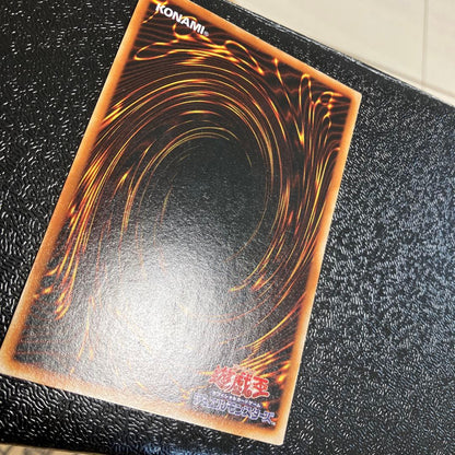 Bandai Toon Black Magician Girl Ultra Rare trading card showing visible wear, dents, creases, and chips