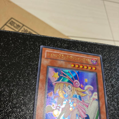 Bandai Toon Black Magician Girl Ultra Rare trading card showing visible wear, dents, creases, and chips